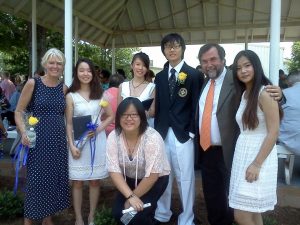 Marcy and Jim Heffinger are shown with some exchange students at graduation.